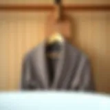 A stylish wooden bathrobe hanger displaying an elegant bathrobe