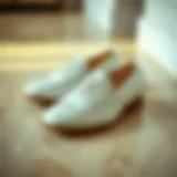 Elegant all-white leather nursing shoes on a polished floor