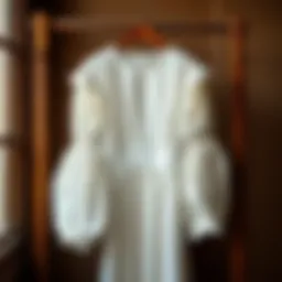Elegant white lantern sleeve dress hanging on a vintage wooden rack