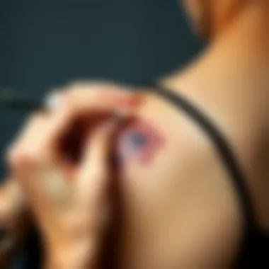 Applying a small flower tattoo on skin