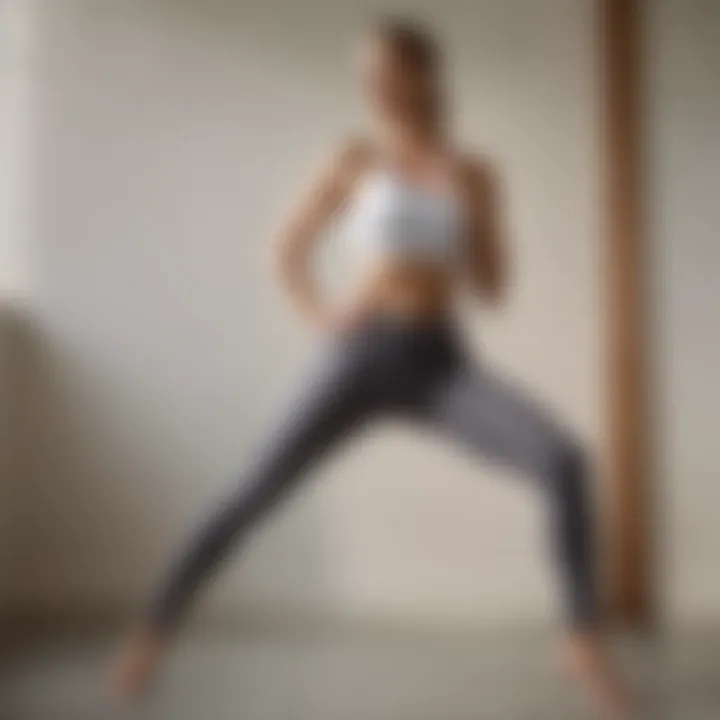 A model wearing yoga pants with a foldover waistband, demonstrating dynamic movement in a serene environment.