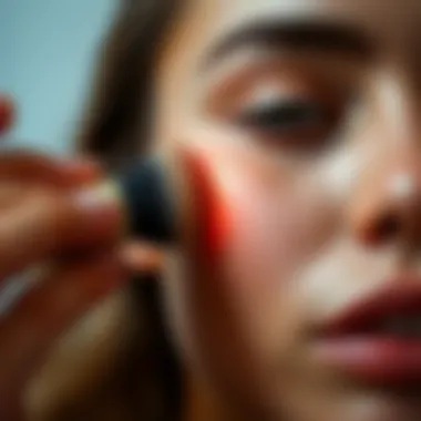 Close-up of non-shimmery highlighter being applied to the skin with a brush.
