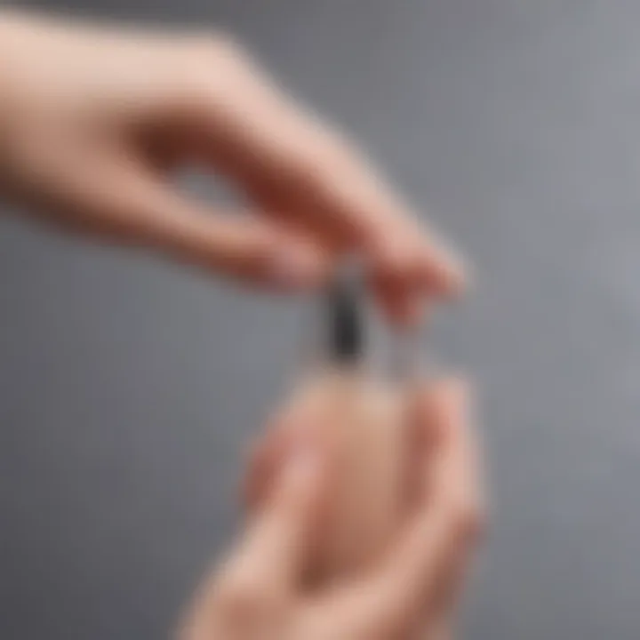 Close-up of a hand using a refillable perfume atomizer