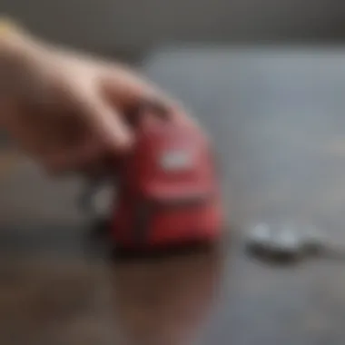 Person using a tiny backpack keychain as an organizational tool