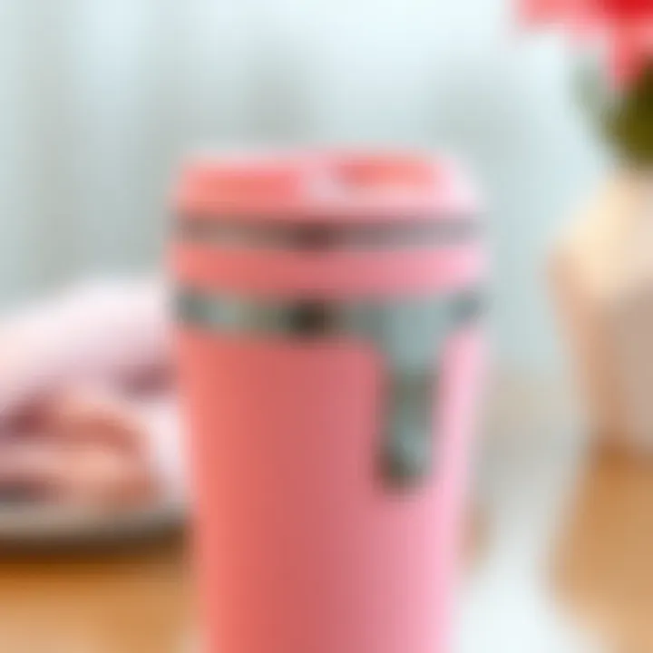 Close-up of a pink travel coffee mug showcasing its unique design features